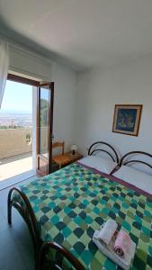 a bedroom with a checkered bed with a window at Albergo ALBERTA in Massa