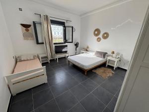 a bedroom with a bed and a chair and a window at Large villa & pool in Mosta in La Celle-sous-Gouzon +31 photos