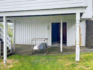 a porch with a table and a chair on it at 4 person holiday home in EGERSUND-By Traum in Egersund