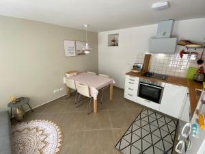 a small kitchen with a table and a small kitchen with a table and a dining at Hidden Hideaway in Cres +20 photos
