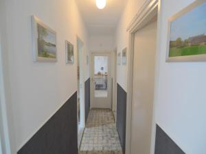 a hallway of a house with white walls at Holiday Home Koewacht near Seaside in Nieuwemolen