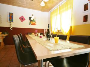 a dining room with a long table and chairs at Chalet in Fürth near Zell am See Ski Slopes in Piesendorf