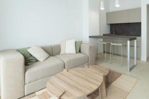 a living room with a couch and a table at Cálida apartments in Cefalù