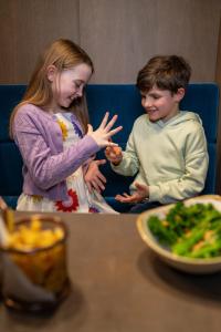 a boy and a girl eating food at a table at Clayton Hotel Silver Springs in Cork