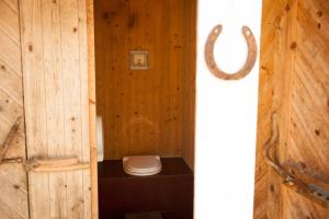 a bathroom with a toilet in a wooden wall at Styrsö Boende och Havsbad in Strömstad +77 photos