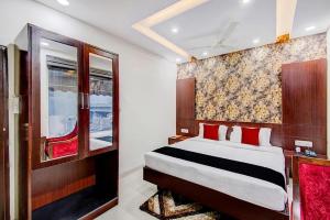 une chambre avec un grand lit avec des oreillers rouges dans l'établissement LRC Hotel & Banquet Zirakpur, à Mohali