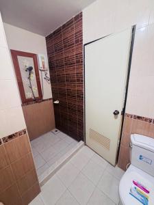 a bathroom with a shower and a toilet at Jura 88 Guesthouse in Hua Hin +14 photos