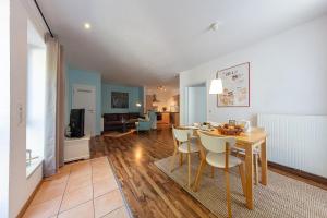 a dining room with a table and chairs and a living room at Ferienwohnungen Wildblume in Winsen Aller +19 photos