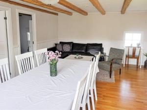 a living room with a table with flowers on it at 4 person holiday home in Väckelsång in Väckelsång