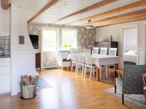 a kitchen and dining room with a table and chairs at 4 person holiday home in Väckelsång in Väckelsång