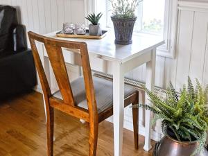 a white table with a chair and plants on it at 4 person holiday home in Väckelsång in Väckelsång +12 photos