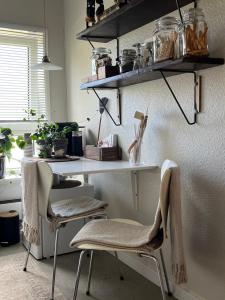 a room with a desk with two chairs and shelves at Palm Beach in Frederikshavn