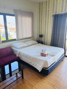 a bedroom with a large bed with a bowl on it at Jura 88 Guesthouse in Hua Hin