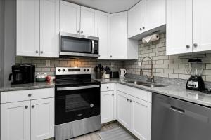 a kitchen with white cabinets and a black stove top oven at Gum Tree 5 with Wintergreen Advantage in Wintergreen