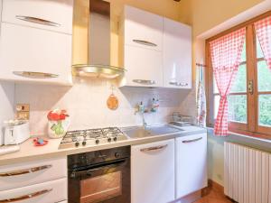 a kitchen with a sink and a stove top oven at Scenic Stay in Restored Retreat in Monterchi