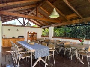 a dining room with wooden tables and chairs at Anahouse in Vişeu de Sus