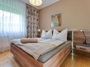 a bedroom with a large bed with white pillows at Bungalow in Glödnitz near Nockberge Alps in Glödnitz