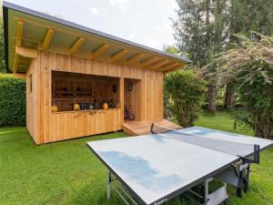 a ping pong table in front of a shed at Bungalow in Glödnitz near Nockberge Alps in Glödnitz
