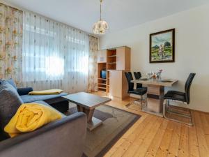 a living room with a couch and a table at Bungalow in Glödnitz near Nockberge Alps in Glödnitz