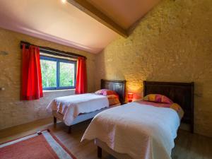 ein Schlafzimmer mit zwei Betten und einem Fenster mit roten Vorhängen in der Unterkunft Poolside Haven in Salles in Larzac