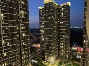 two tall buildings in a city at night at The Place- Vinhome Grand Park Q9 in Long Bình