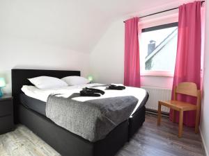 a bedroom with a large bed with pink curtains at Villa in Bruinisse near Grevelingenmeer in Bruinisse +32 photos