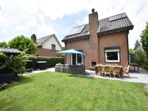 a yard with chairs and a house at Villa in Bruinisse near Grevelingenmeer in Bruinisse