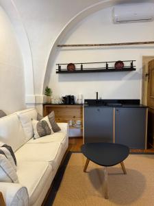 a living room with a white couch and a table at Stadtjuwel am Neusiedlersee in Rust +42 photos