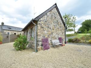 a stone building with a bench in front of it at Holiday Home Saint-Gilles near Beach in Saint-Gilles-les-Bois