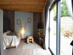 a bedroom with a bed and a large window at Holiday Home Saint-Gilles near Beach in Saint-Gilles-les-Bois +32 photos