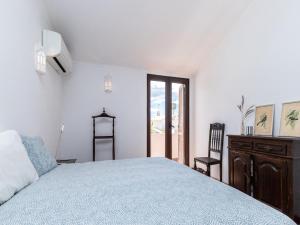 a bedroom with a bed and a dresser and a window at Akivillas Quarteira Lighten in Quarteira