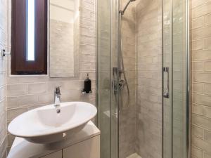 a bathroom with a sink and a glass shower at Akivillas Quarteira Lighten in Quarteira +13 photos