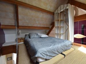 a bedroom with a bunk bed and a ladder at Holiday Home Saint-Gilles near Beach in Saint-Gilles-les-Bois