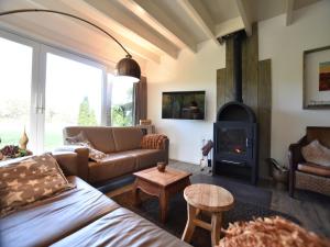 a living room with a couch and a fireplace at Holiday Home in Reutum with Bubble Bath in Beekdorp