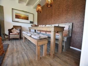 a living room with a wooden table and a bench at Holiday Home in Reutum with Bubble Bath in Beekdorp