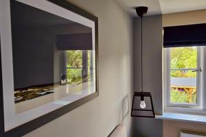 a mirror hanging on a wall with a window at Newbury Garden Retreat in Headley +69 photos