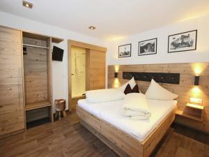 a bedroom with a bed with white sheets and pillows at Apartment in See near Ski Slopes in See
