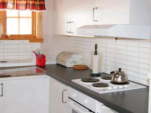 a kitchen with a stove with a tea kettle on it at 6 person holiday home in Nordli-By Traum in Holand +30 photos