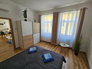 a living room with a bed and a large window at GUDU apartments in Košice +45 photos