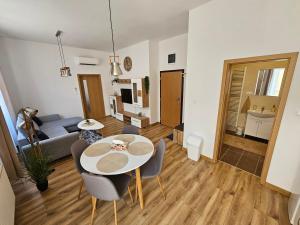 a living room with a white table and chairs at GUDU apartments in Košice