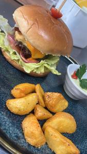 a plate with a sandwich and french fries on it at Desirée Aeroporto Congonhas 2 in Sao Paulo