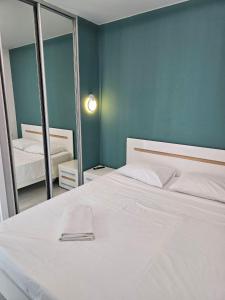a bedroom with a white bed and a mirror at Nyvky Like Home - Файна Таун із сезонним басейном - Кв 6 низький поверх in Kyiv +23 photos