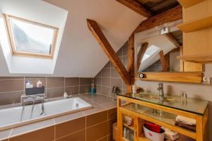 a bathroom with a bath tub and a sink at Maison chaleureuse à Faverges Seythenex avec terrasse in Vésonne +15 photos