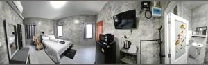 a bedroom with a bed and a tv on the wall at Baan Raweewan Resort in Ban Phu Yai