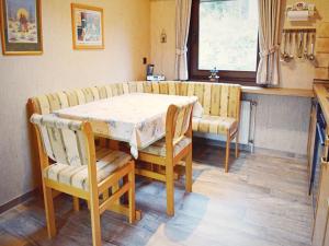 a dining room with a table and chairs and a window at Furnished Bungalow With Peaceful Neighbourhood in Meschede