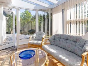 a living room with a couch and a glass table at 4 star holiday home in Højslev in Højslev