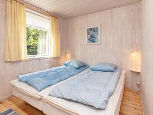a large bed in a room with a window at 4 star holiday home in Højslev in Højslev +51 photos