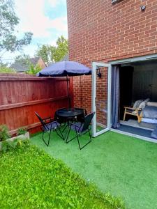 a patio with a table and chairs and an umbrella at Bavelle Bilston Urban Village in Bilston +19 photos