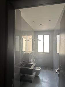 a bathroom with a sink and a toilet at Masaken Hotel Apartment in Amman +35 photos