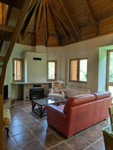 a living room with a red couch and a table at SNÖ Apartamentos Escarrilla in Escarrilla +32 photos
